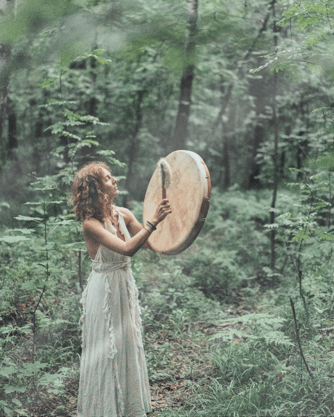 Woman with frame drum in nature
