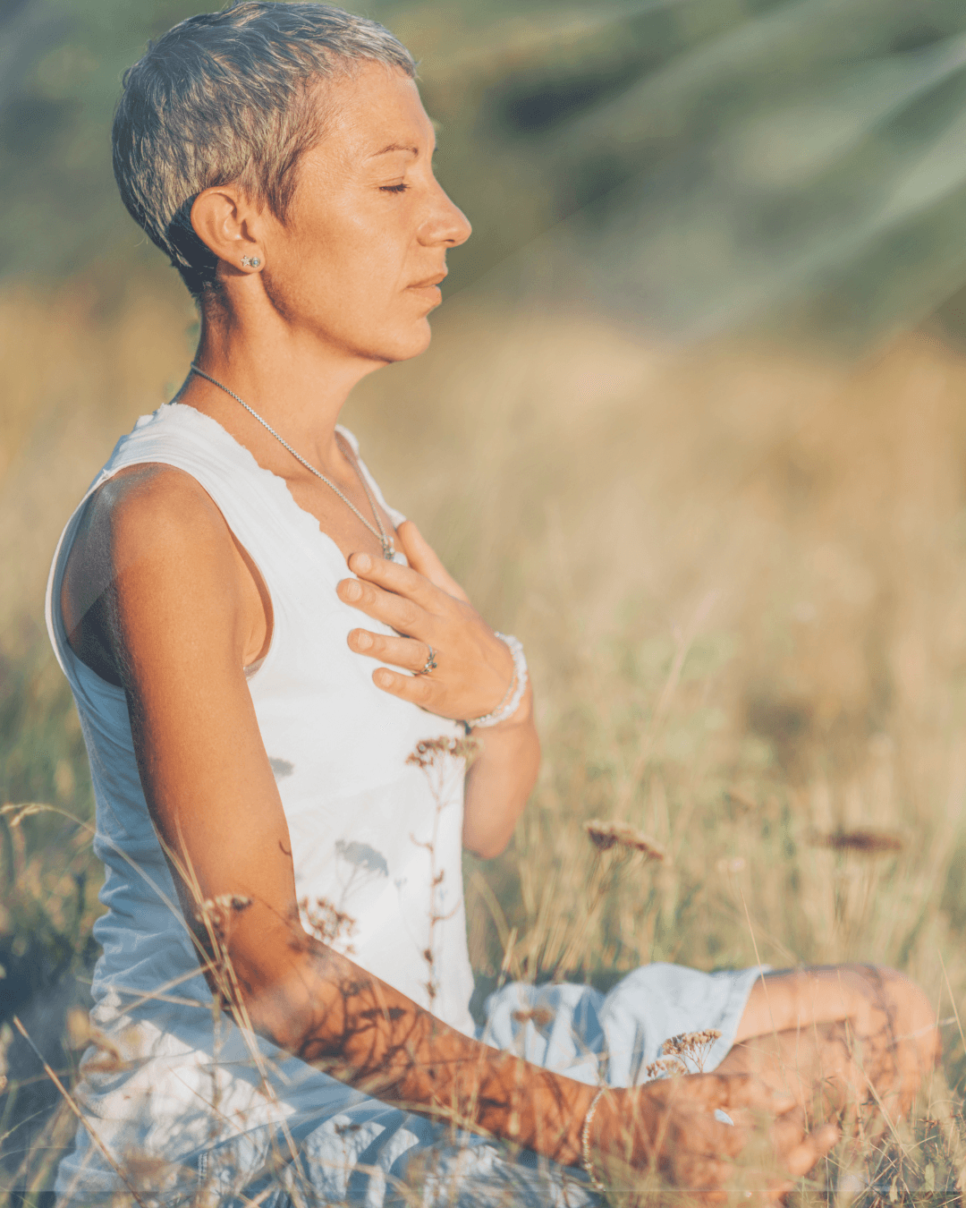 Woman meditating in a sunlit field